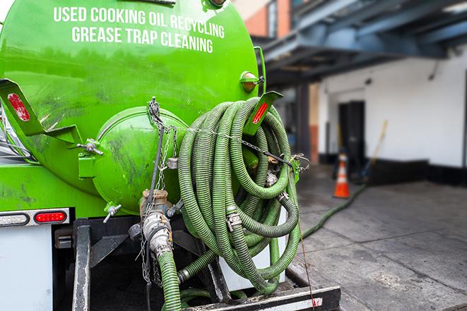 a technician pumping a grease trap in a commercial building in Los Altos Hills